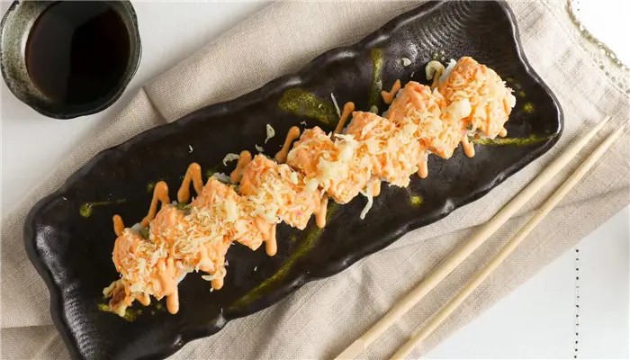 Deep fried spicy tuna roll top w.scallion, tobiko, eel sauce, spicy mayo at Ikoi Sushi, a Sushi restaurant in San Rafael